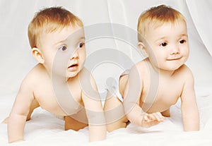 Two charming twins babies crawling