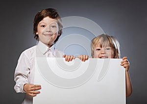 Two cheerful boy holding a banner