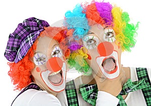 Two clowns made up in costume for carnival scream and shout out loud photo