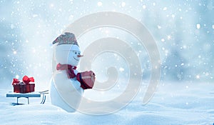 Two cheerful snowman standing in winter christmas landscape. Winter fairytale.Snowfall in the magic forest.Merry christmas and