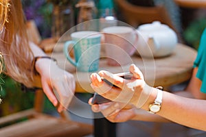Two cheerful women having friendly chat in cafe