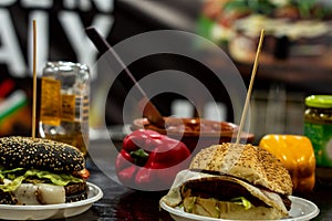 Two cheese burgers on a table on street food counter