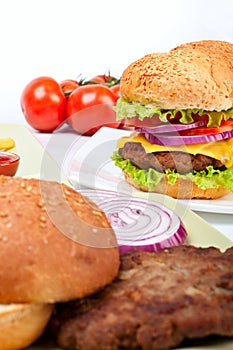 Two cheeseburgers with ingredients