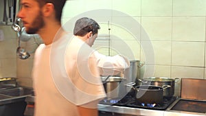 Two chefs cooking in the restaurant kitchen