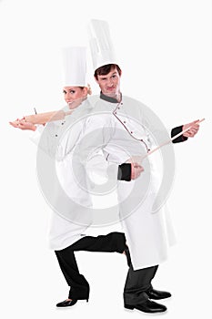 Two chefs with kitchen utensils