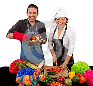 Two chefs preparing for a Mexican celebration