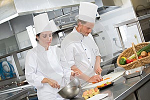 Two chefs preparing in restaurant kitchen