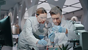 Two chemist looking samples innovation medicines in advanced laboratory close up