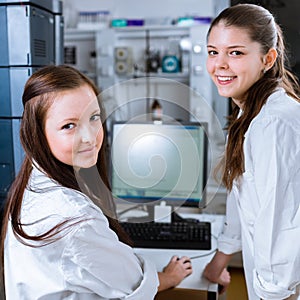 Two chemistry students carrying out experiments in a lab photo