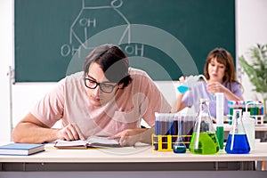 Two chemists students in classroom