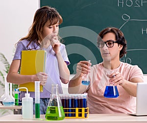 Two chemists students in classroom