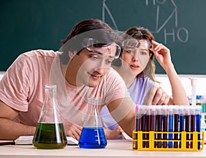 Two chemists students in classroom