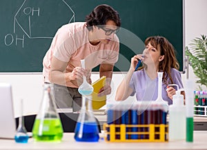 Two chemists students in classroom