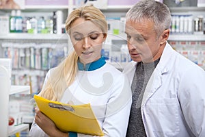 Two chemists working at drugstore together