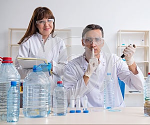 Two chemists working in the lab