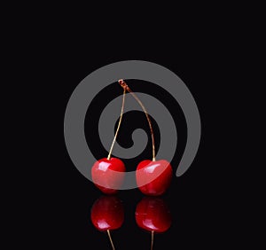 two cherries on black