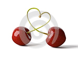 Two cherries on one stem a heart-shape isolated on white background