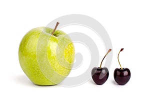 Two cherry berries and one big green apple on white background isolated close up macro