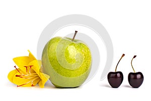 Two cherry berries and one big green apple on white background isolated close up macro