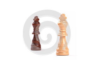 Two chess pieces. Black and white king of wood with blurred background - Isolated on white