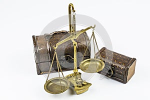 Two chests and old bronze scales isolated on a white background