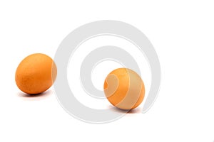 Two chicken brown eggs on a white background