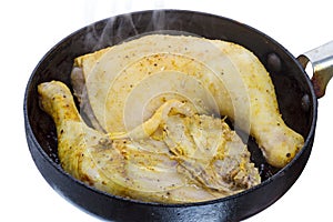 Two chicken legs on a hot pan