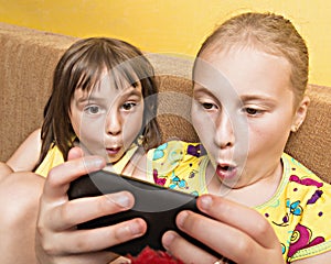 Two child play on your mobile phone.