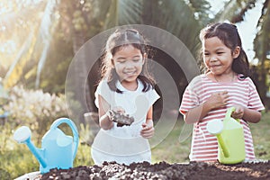 Two children asian little girl having fun to prepare soil