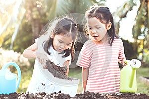 Two children asian little girl having fun to prepare soil