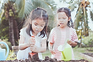 Two children asian little girl having fun to prepare soil