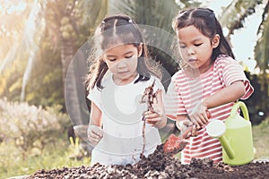 Two children asian little girl having fun to prepare soil