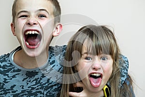 Two children boy and girl fooling around having fun together. Happy childhood concept