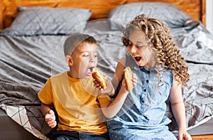 Two children brother and sister eat buns photo