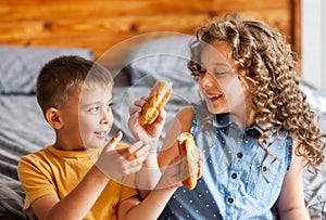 Two children brother and sister eat buns photo