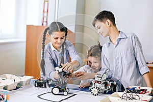 Two children, brother with sister enaging in their hobby-constructing robot toys