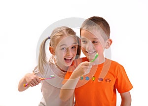 Two children brush their teeth isolated on white