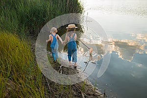 Two children with a butterfly net near the river