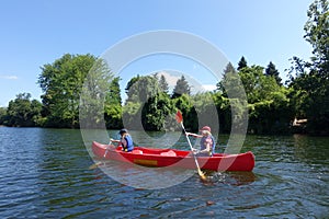 Two children canoing on the River lot