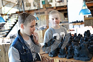 Two children choosing souvenirs shungite