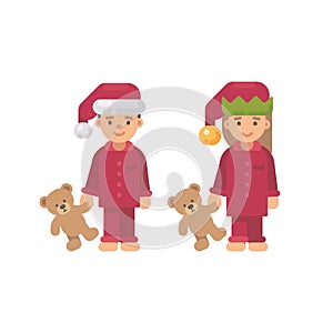 Two children in Christmas hats and red pajamas holding toys photo