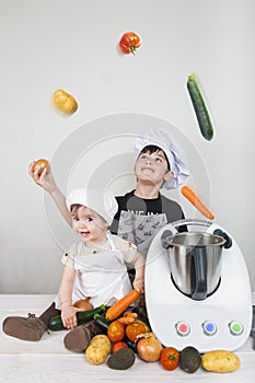 Two children cooking with a futuristic machine