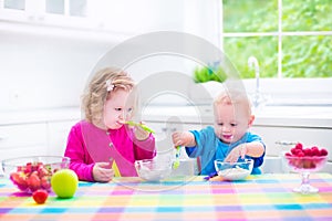 Two children eating yoghurt