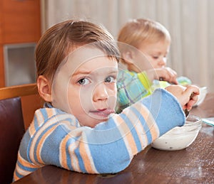 Two children eating yogurt