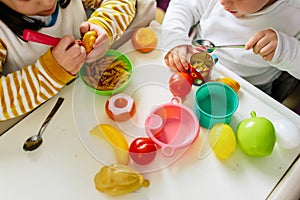 Two children entertain themselves with food toys. Playing at home during confinement