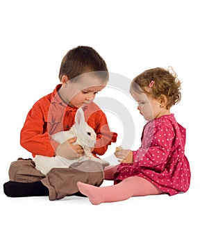 Two children feeding a bunny