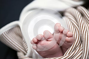 Two children feet wrapped in blanket