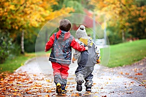 Two children, fighting over toy in the park on a rainy day