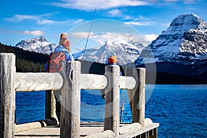 Two children fishing off a dock near Banff Canada