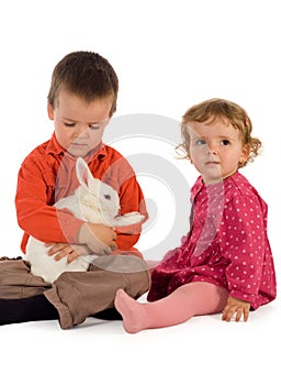 Two children getting acquainted with a bunny